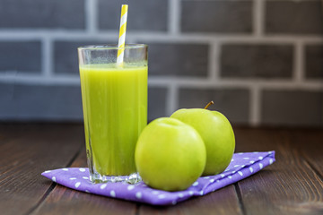 Detox apple. Wooden table. Copy space. The concept is healthy food, vegan, diet, weight loss.