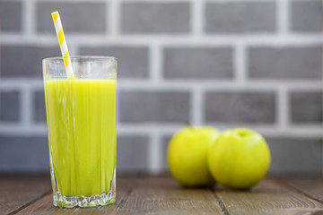 Fresh juice in a glass. Green apple. Copy space. The concept is healthy food, vegan, diet, weight loss.