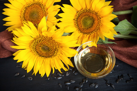 Sunflower oil and sunflowers on black