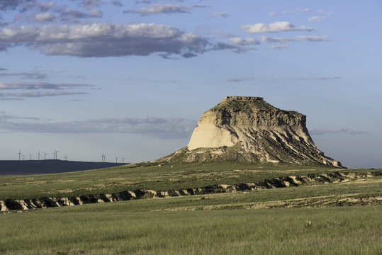 West Pawnee Butte On The Pawnee National Grassland In Northeastern Colorado. A Wind Farm Is Along The Horizon.