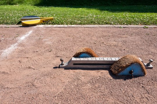 Startblock auf der Aschenbahn eines Schulsportplatzes