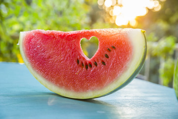 Watermelon with a heart at sunset