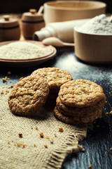 Biscuit sweet cookie background. Domestic stacked butter biscuit pattern concept,close up macro.Homemade cookies on wooden table.Cereal biscuits with the sesame,peanuts,sunflower and amaranth.