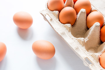 Chicken eggs in a box on a white background