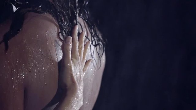 close-up. slow motion. woman's hand glides along the wet back is another girl. same-sex love. smooth healthy female skin