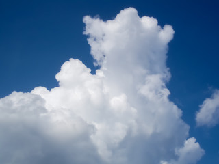 Naklejka na ściany i meble White puffy cumulus clouds in blue sky 