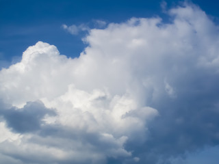 Naklejka na ściany i meble White puffy cumulus clouds in blue sky 