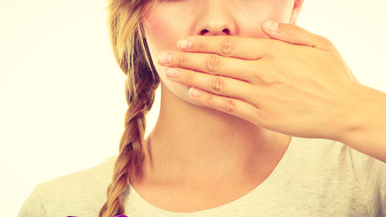 Sad woman covering mouth with hand