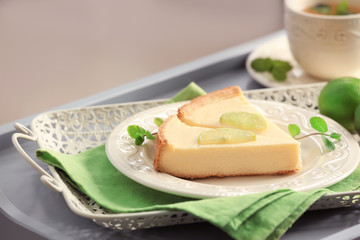 Plate with delicious slices of cheesecake on green napkin