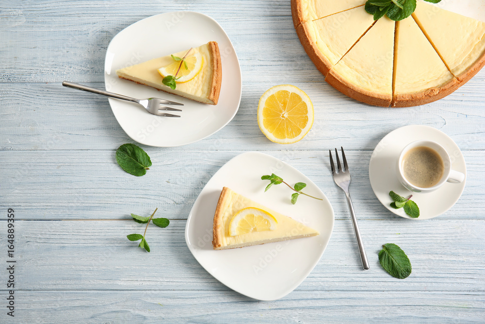 Poster plates with delicious cheesecake and cup of coffee on wooden table