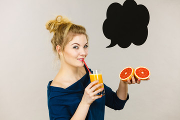 Happy woman holding fresh orange juice