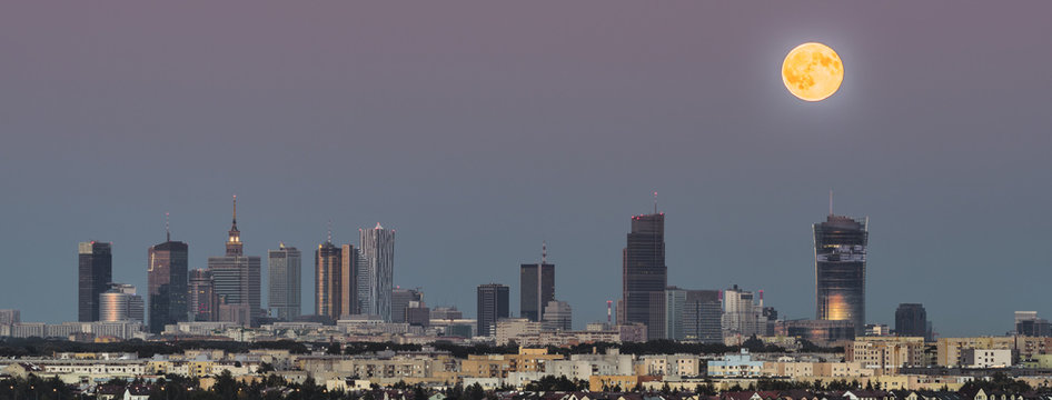 Panorama of rising moon over Warsaw city, Poland