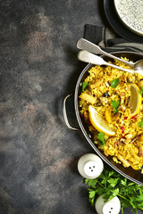 Traditional spanish (valencian) dish paella - stew with rice and seafood.Top view with copy space.