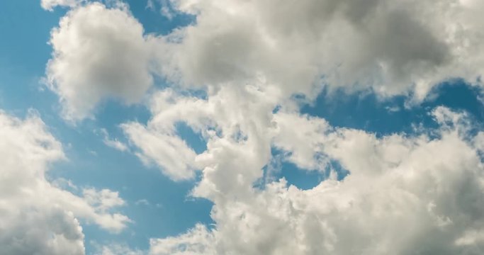 Time lapse clip of white fluffy curly rolling clouds