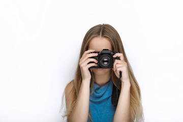 Headshot of young adorable playful blonde woman with cute smile in cobalt color blouse taking...