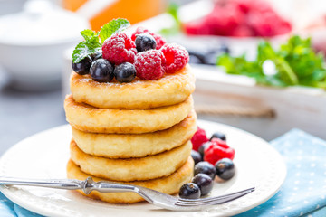 Cottage cheese pancakes, syrniki, curd fritters with berries