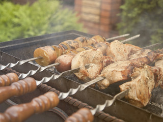 Barbecue meat and potatoes on the grill, skewers