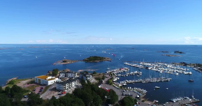 Regatta, Cinema 4k aerial view over Hanko ita-satama, full of boats and towards the racing sailboats, on Hango regatta day, in Uusimaa, Finland