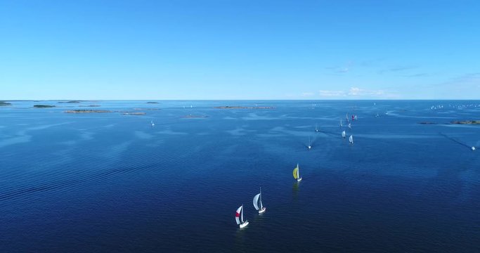 Regatta, Cinema 4k aerial view following around the racing sailboats, at the yacht competition, on Hango regatta day, in Uusimaa, Finland