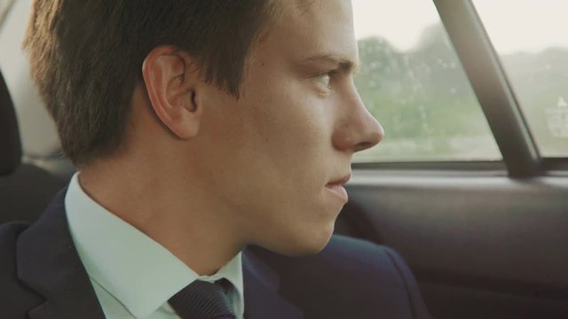 Portrait of handsome sad businessman in the car 4K