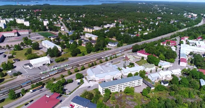 Train in the city, Cinema 4k aerial view around a old cargo train, in downtown Hanko, on Hango regatta day, in, Uusimaa, Finland