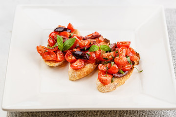 Italian bruschetta with chopped tomatoes, basil and olive