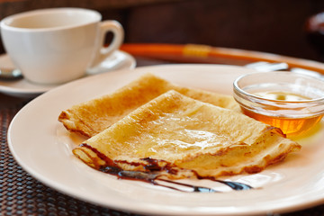 Pancake with honey and a cup of green tea