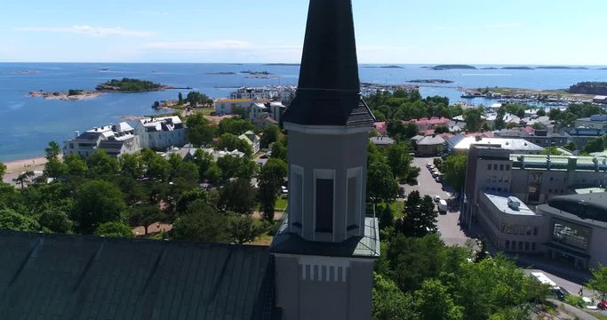 Hanko church, Cinema 4k aerial view slowly rising around the church, revealing sailboats on the sea, on Hango regatta day, in Finland