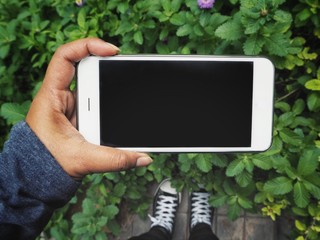 Smart phone on hand in the garden