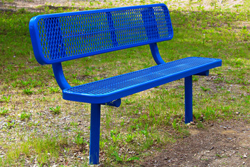 A blue metal mesh bench on the grass