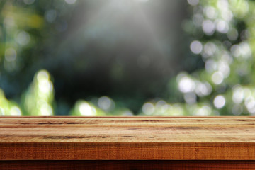 Wooden table and blurred nature background.