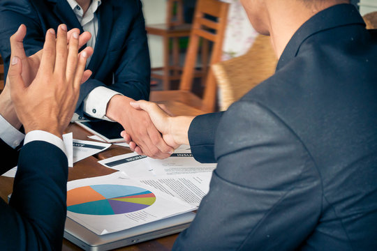 (Businessmen shaking hands), Businessmen shaking hands, businessman standing by his car using mobile phone