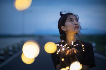 Young woman with fairy light
