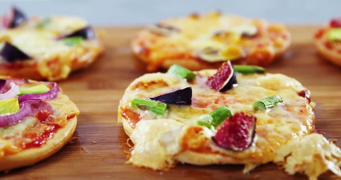 Various pizzas on wooden board