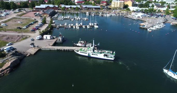 HANKO, UUSIMAA, FINLAND, JULY 7, Cinema 4k aerial view of bengtskar ferry docking in hango city, in the finnish archipelago of the baltic sea, in Finland