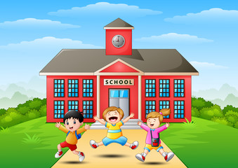 Obraz na płótnie Canvas Happy school children jumping in front of school building