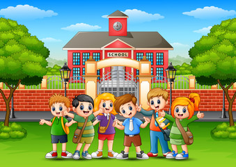 Obraz na płótnie Canvas Happy school children standing in front of school building