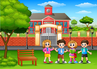 Fototapeta na wymiar Happy school children standing in outside the front of school building