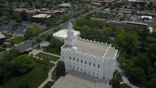 Aerial St George Utah LDS Temple circle side white building. Flight over sacred Temple, Church of Jesus Christ of Latter-day Saints, Mormon or LDS. Built late 1800's. Pioneer white stone structure.