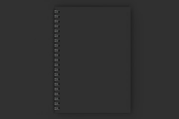 Closed notebook spiral bound on black background - 164910992