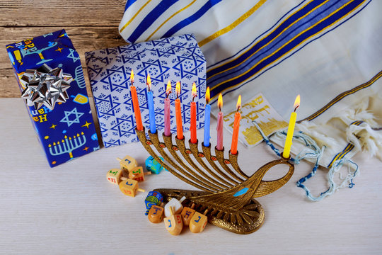 jewish holiday Hanukkah with menorah over wooden table