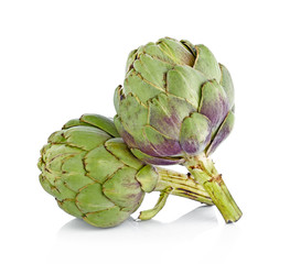 Obraz premium Two fresh artichokes with stem and leaf and a half showing the heart. Isolated.