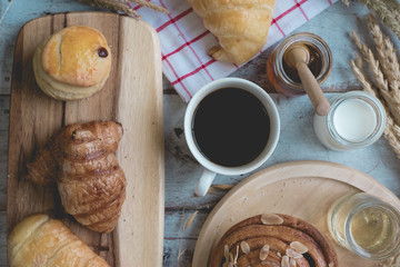 Coffee and fresh breads served for breakfast on wooden trays, a perfect way to start the day