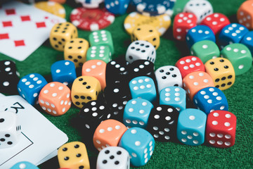 Gambling chips and cards on a green cloth Casino table