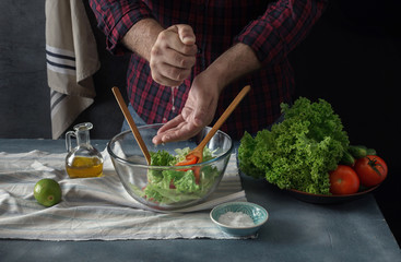 Man cooking vegetable salad home kitchen