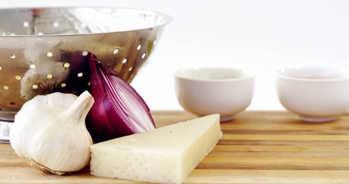 Cheese, onion and garlic with colander
