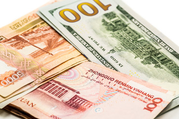 different currency banknotes. dollars, yuan and rubles on white