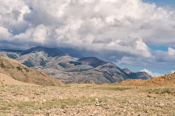 Big cloud lying on a hilltop in Altai