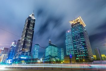 Plakat urban traffic with cityscape at night in city of China.