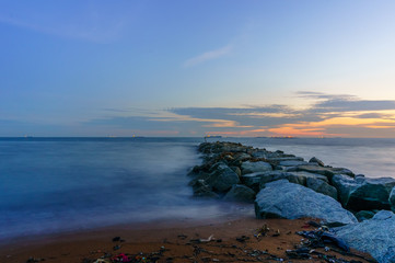 Sea waves lash line impact rock on the beach